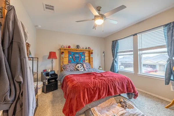 a bed sitting in a bedroom next to a window