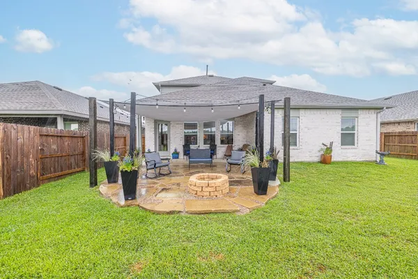 a view of a house with backyard porch and furniture