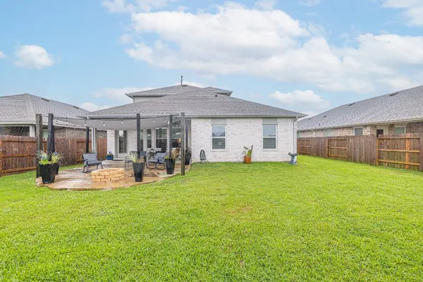 a view of a house with backyard porch and sitting area