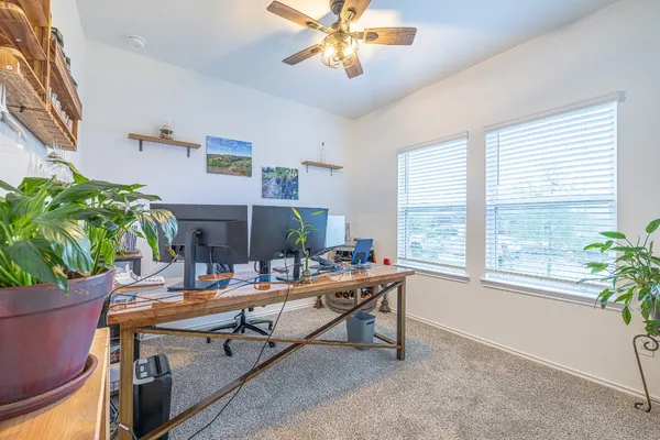 a work room with furniture and a potted plant
