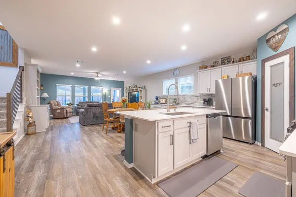 a open kitchen with stainless steel appliances granite countertop a lot of counter space and wooden floors