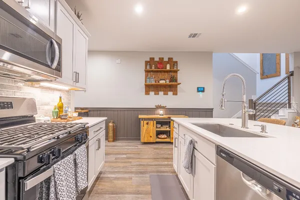 a kitchen that has a sink and a stove