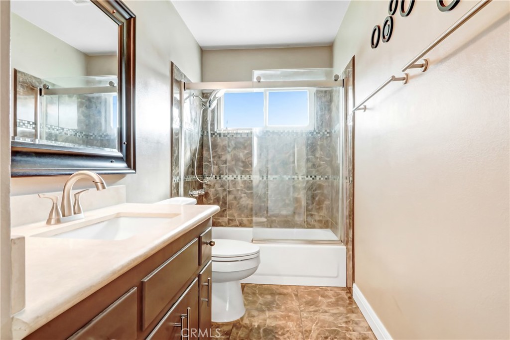 1277 West 14th Street Upland, CA 91786 - Photo 5 of 11 a bathroom with a sink a toilet and shower