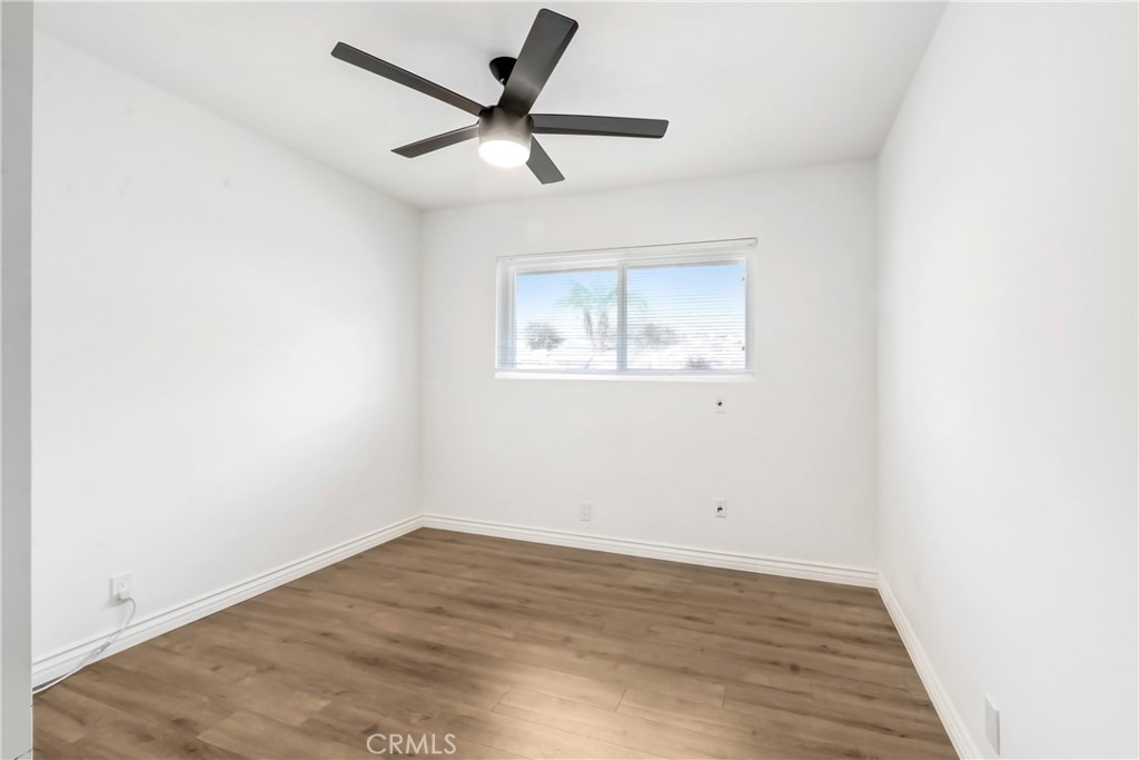 1277 West 14th Street Upland, CA 91786 - Photo 7 of 11 an empty room with wooden floor and windows