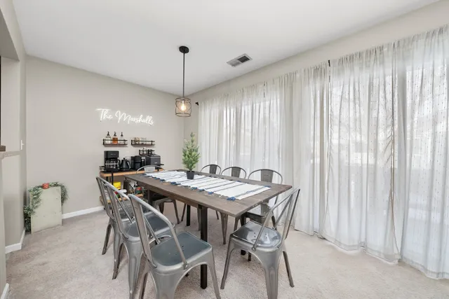 a view of a dining room with furniture window and outside view