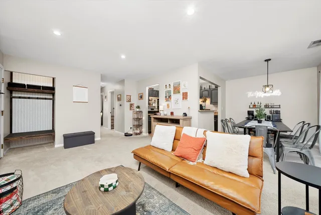 a living room with furniture and kitchen view