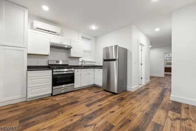 a kitchen with stainless steel appliances a refrigerator sink and cabinets