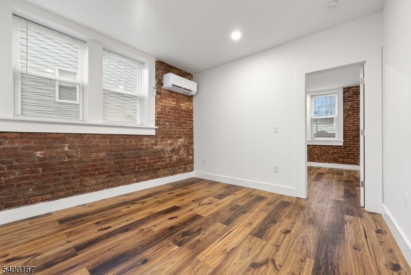 200 Forest Street, Unit R Montclair, NJ 07042 - Photo 4 of 13 a view of an empty room with wooden floor and a window