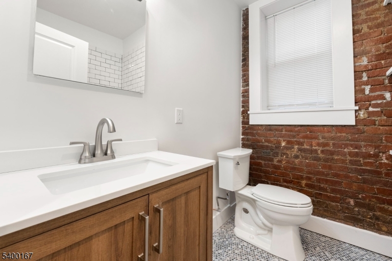 200 Forest Street, Unit R Montclair, NJ 07042 - Photo 7 of 13 a bathroom with a sink a toilet and mirror