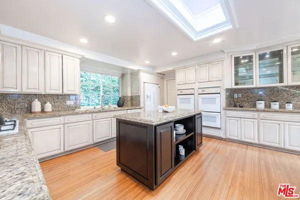 a kitchen with stainless steel appliances granite countertop a stove and cabinets