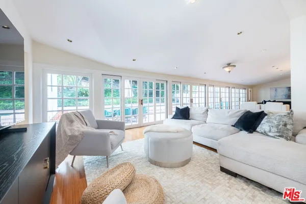 a living room with furniture and large windows