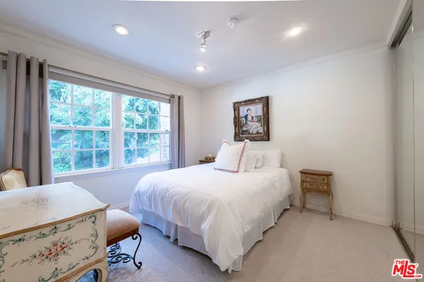 a bedroom with a bed and a chair