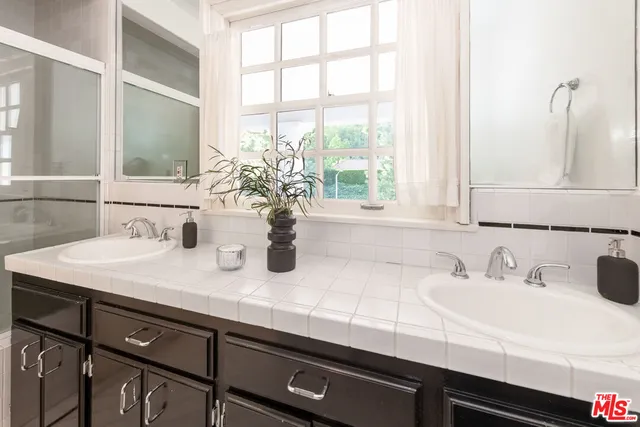 a bedroom with a large bed and a view of kitchen