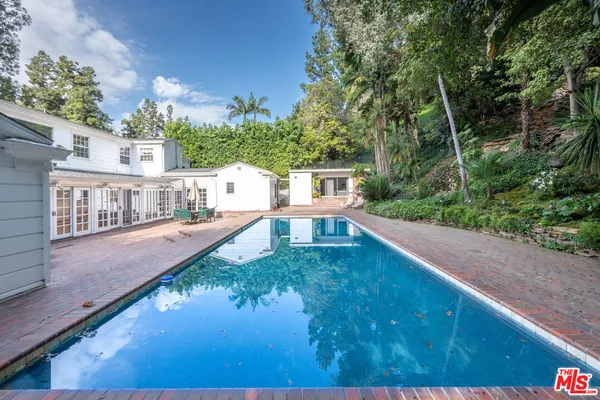 a view of a swimming pool with a yard