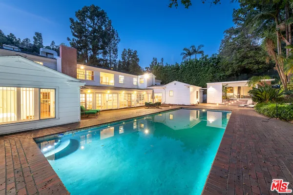 a view of a swimming pool with a yard