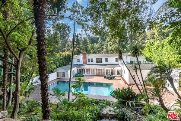 a balcony with tall trees