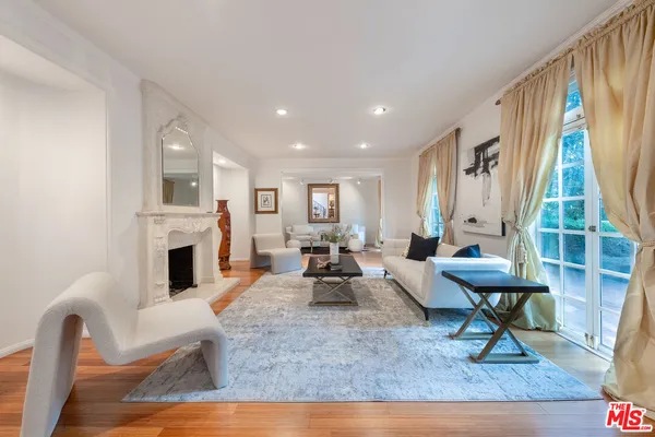 a living room with furniture a fireplace and a table