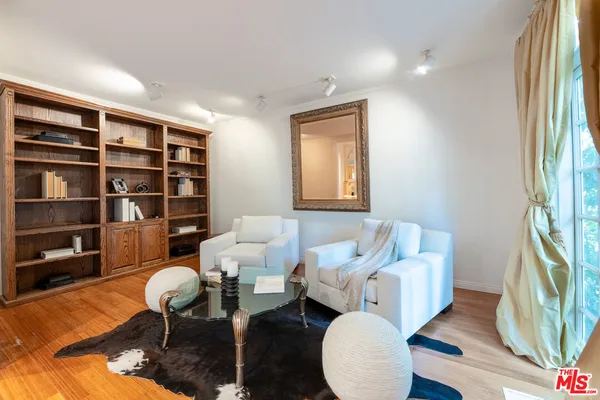 a living room with furniture a rug and a window