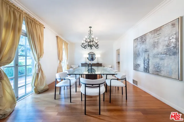 a living room with furniture and large windows