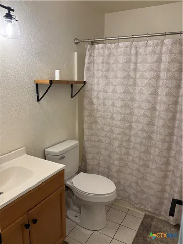 a bathroom with a toilet a sink and shower