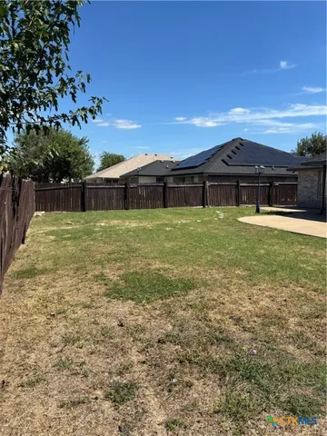 a swimming pool with outdoor seating and yard