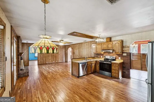 a kitchen with stove a sink and refrigerator