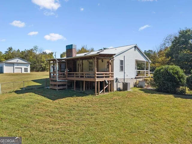 a view of a house with swimming pool and a yard