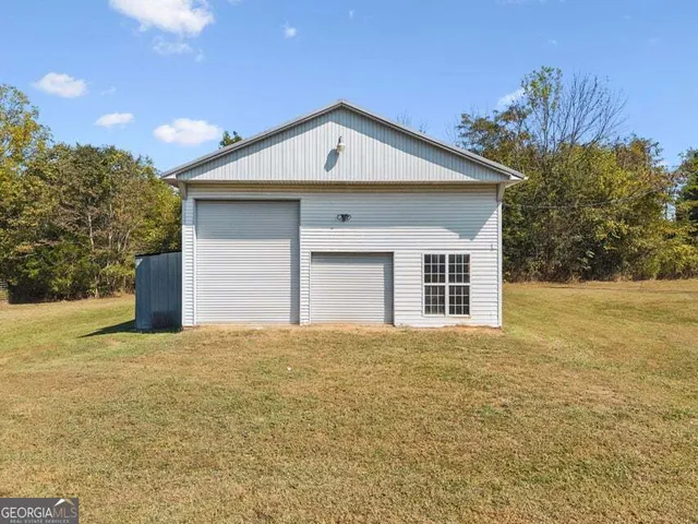 a view of a house with a yard and garage