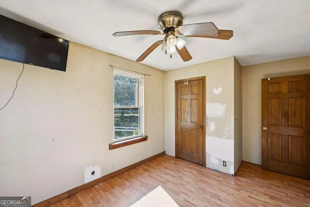 wooden floor in an empty room with a window