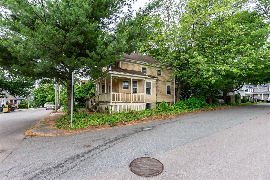 270 Garden Street Fall River, MA 02720 - Photo 27 of 36 a front view of a house with a yard and a garage