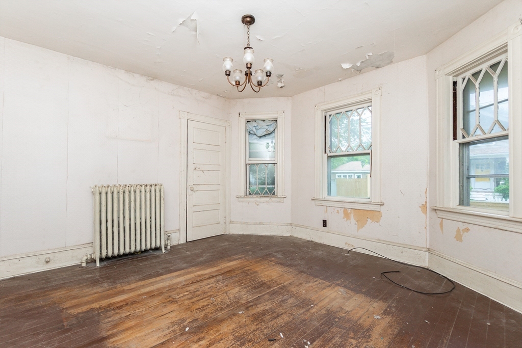 270 Garden Street Fall River, MA 02720 - Photo 3 of 36 an empty room with wooden floor and windows