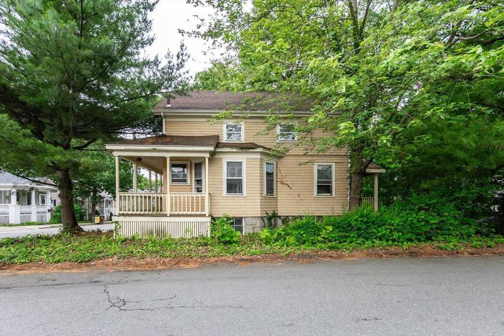 270 Garden Street Fall River, MA 02720 - Photo 32 of 36 a front view of a house with a garden and trees