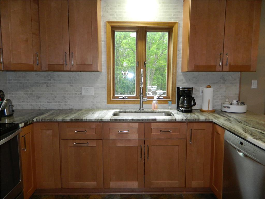 328 Pin Oak Road Stroudsburg, PA 18360 - Photo 17 of 37 A well-appointed kitchen features natural wood cabinetry and exquisite marble countertops, perfect for everyday living.