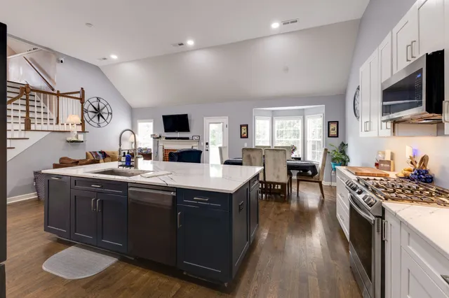 a living room with furniture kitchen view and a fireplace