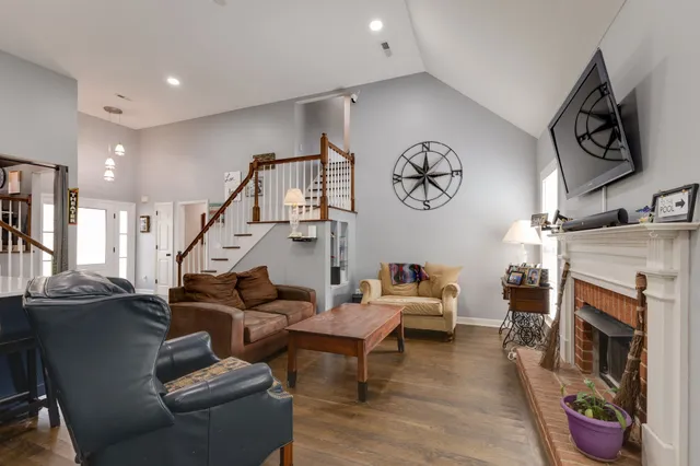 a living room with furniture gym equipment and a flat screen tv