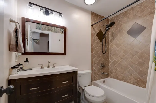 a bedroom with bed and a chandelier