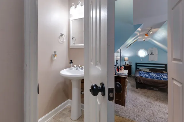 a bedroom with furniture and a mirror