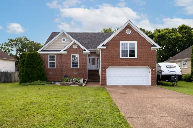 a front view of a house with a yard and garage