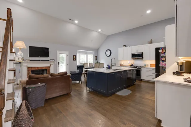 a kitchen with stainless steel appliances granite countertop a sink a stove and a refrigerator