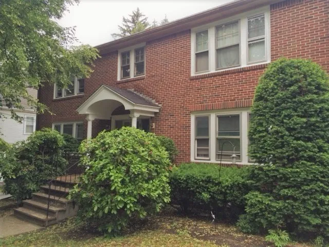 a front view of a house with garden
