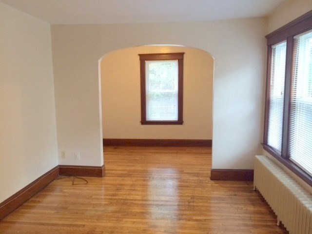 20 Prospect Avenue, Unit 8 Quincy, MA 02170 - Photo 3 of 13 a view of an empty room with wooden floor and a window