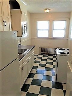 20 Prospect Avenue, Unit 8 Quincy, MA 02170 - Photo 7 of 13 a kitchen with a checkered floor and white cabinets