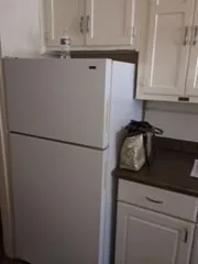 a close view of a refrigerator a sink and cabinets