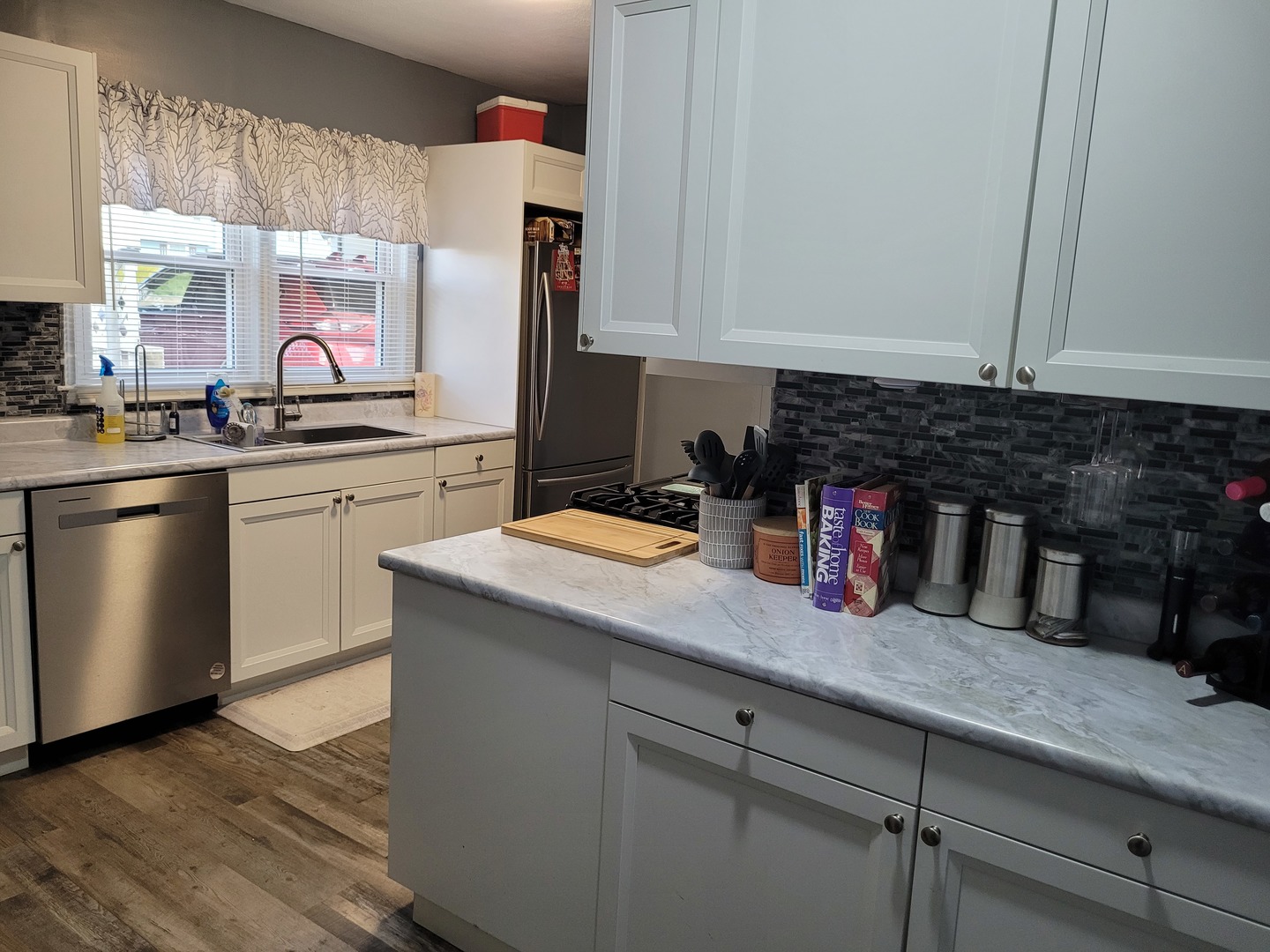 921 Airport Road Mount Vernon, IL 62864 - Photo 13 of 26 a kitchen with stainless steel appliances granite countertop a sink dishwasher a stove and white cabinets with wooden floor