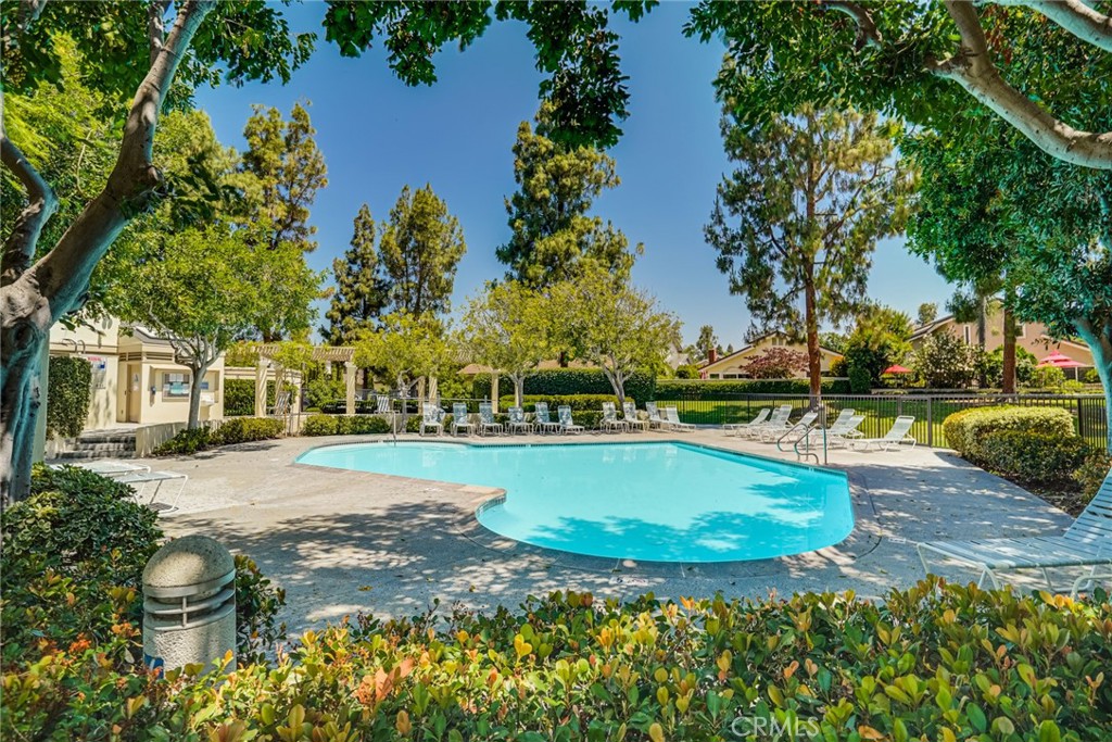 49 East Yale Loop, Unit 26 Irvine, CA 92604 - Photo 61 of 63 a view of a swimming pool with an outdoor space and seating area