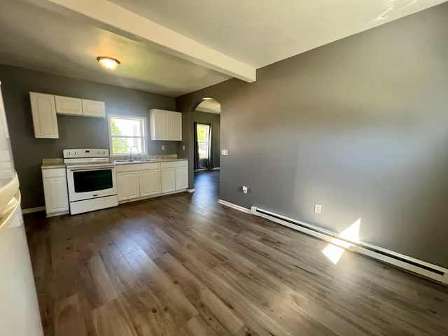 a large kitchen with cabinets and stainless steel appliances