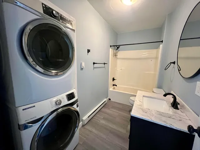 a view of a bathroom with washing machine and sink