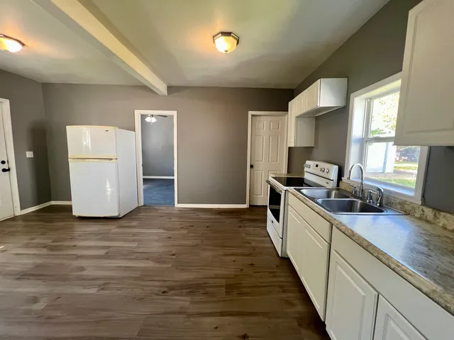 a kitchen with a sink and refrigerator
