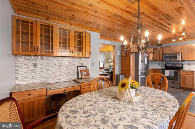 a kitchen with stainless steel appliances granite countertop a sink and cabinets