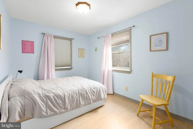 a bedroom with a bed and a chair